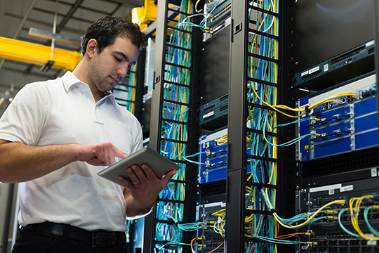 An IT professional in a server room