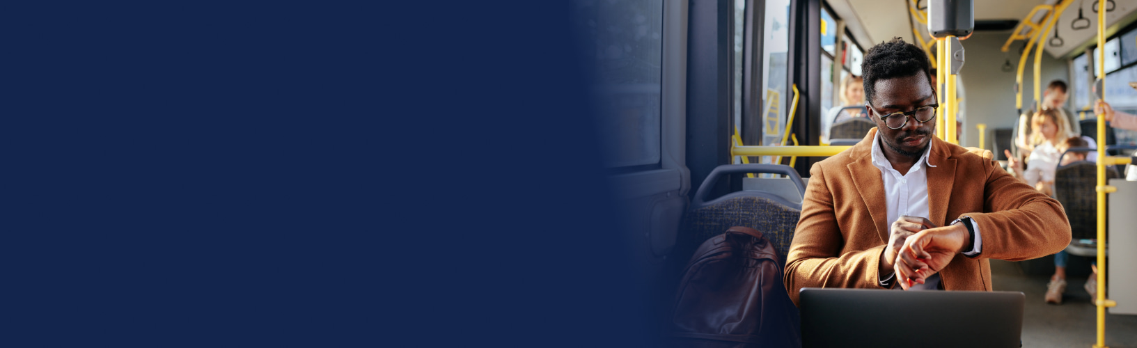 man checks the time on his watch as he sits on the bus