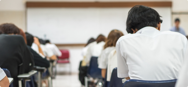 students sitting at desks in classroom