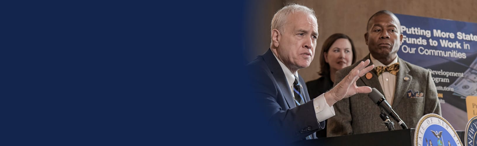 state comptroller dinapoli speaking alongside senator james sanders jr at the minority banks legislation press conference