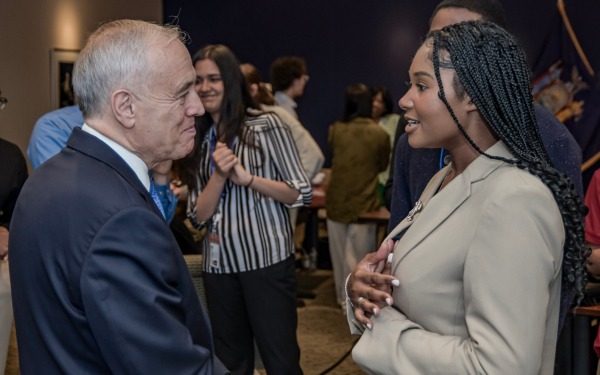 new york state comptroller dinapoli talking to a person at an event