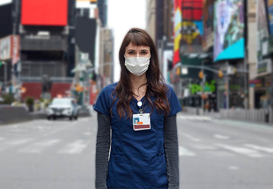 Health worker with mask on standing in Times Square
