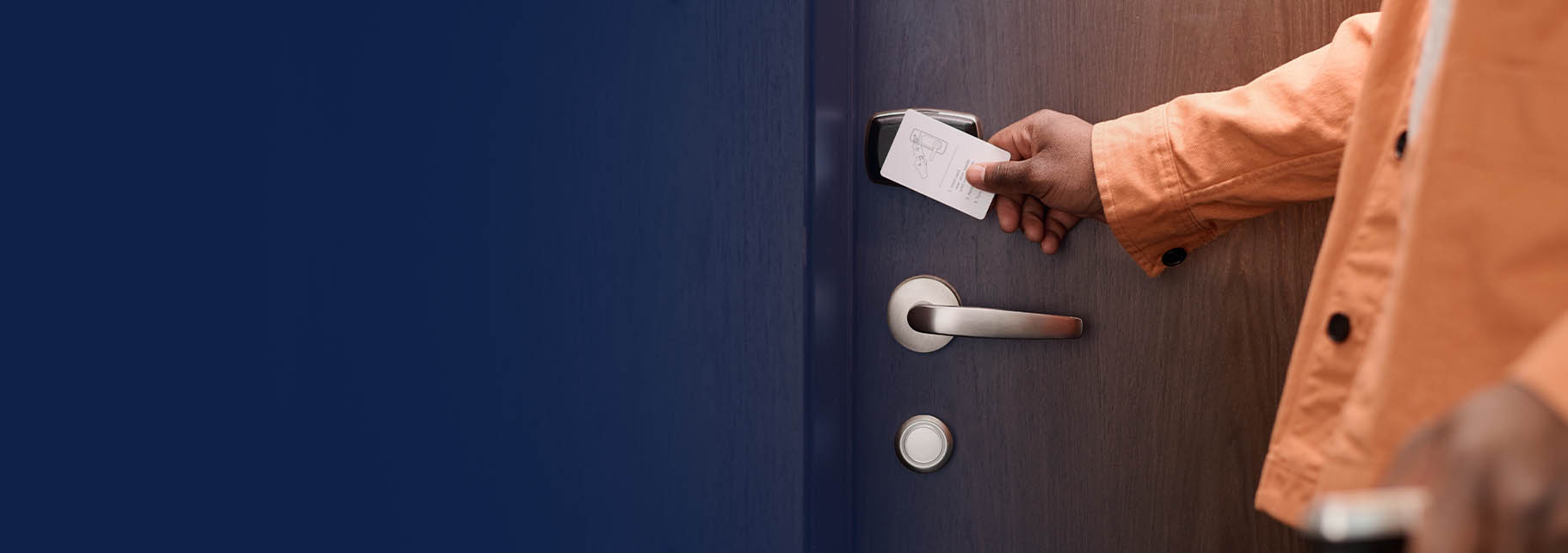 person swiping key card to enter hotel room