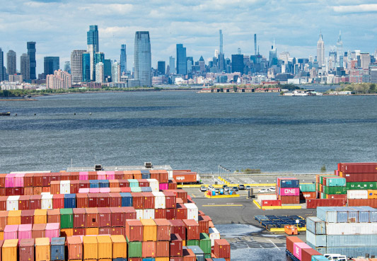 Aerial view of colorful shipping containers at the port of New York and New Jersey with the New York City skyline in the background