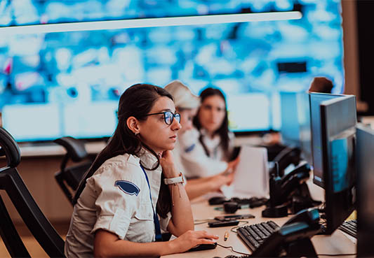 Responder looking at computer screens in call center. 