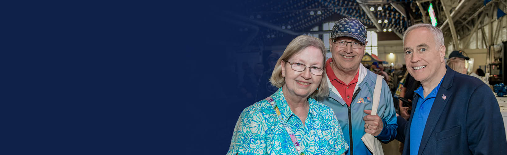 state comptroller dinapoli standing with two new york state retirees at the new york state fair
