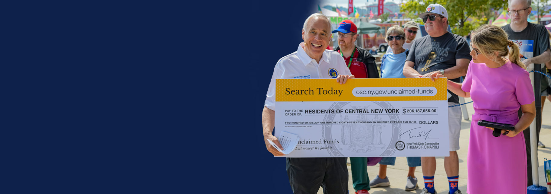 state comptroller dinapoli handing out a large check at the new york state fair press event