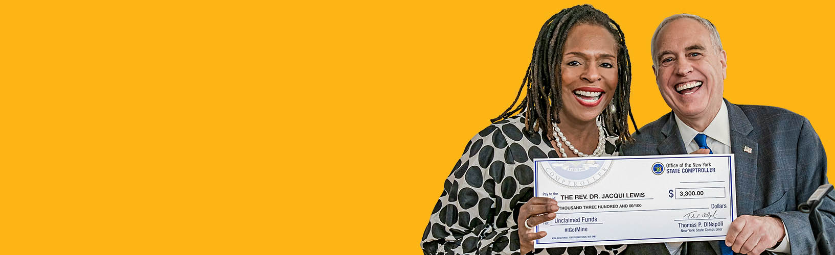 state comptroller dinapoli holding a check with reverend jacqui lewis