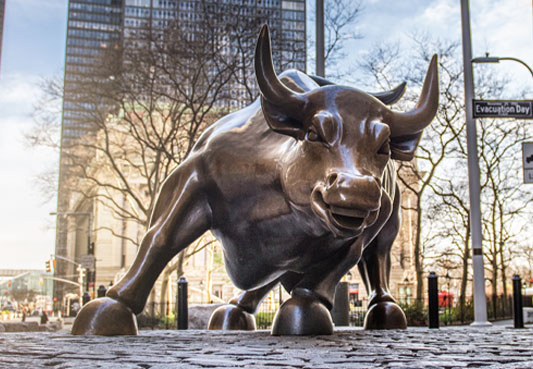 Charging Bull sculpture on empty streets of New York City.