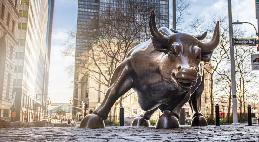 Charging Bull sculpture on empty streets of New York City.