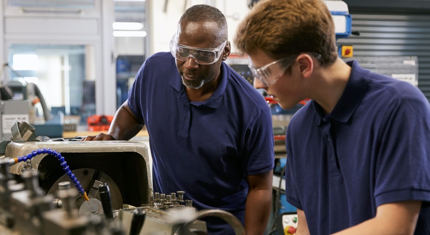 Two workers at a manufacturing plant.