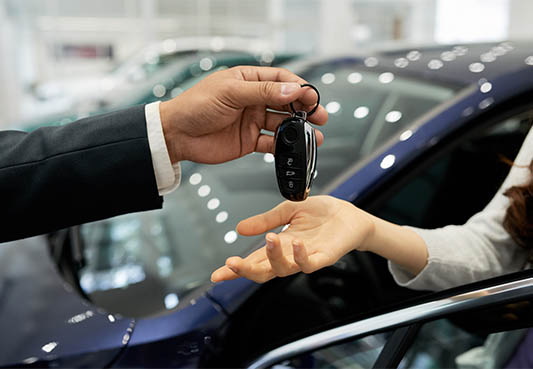 two hands exchanging car keys