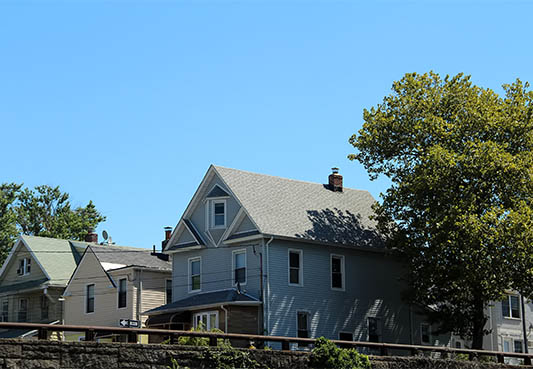 three houses next to each other on a suburban street