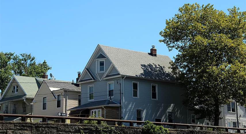 three houses next to each other on a suburban street