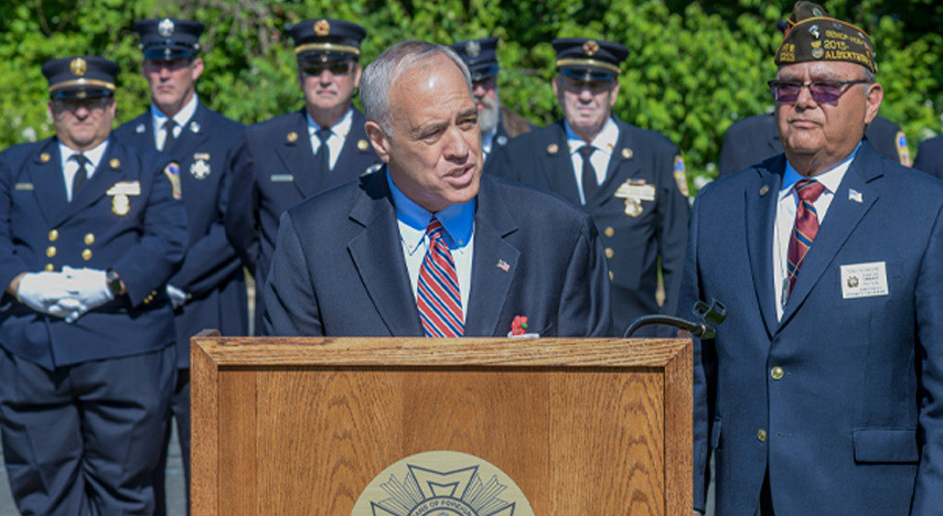 NYS Comptroller Thomas P. DiNapoli speaking at a podium
