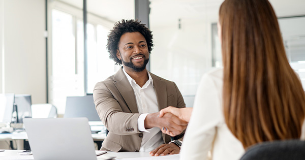 employer shaking hands with employee