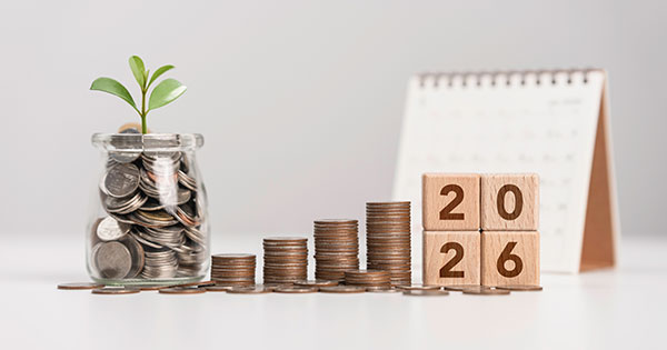 jar with coins rising stacks of coins calendar with 2026