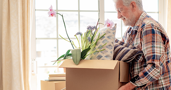 retiree holding moving box