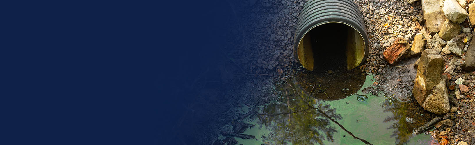 toxic waste water flowing out of sewer pipe