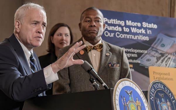 state comptroller dinapoli speaking alongside senator james sanders jr at the minority banks legislation press conference