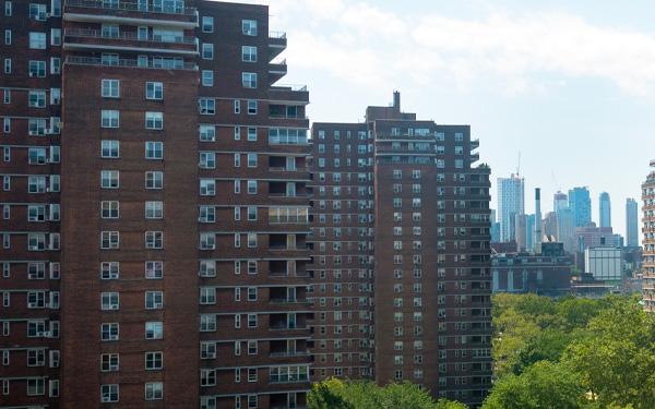 Lower East Side apartment blocks in New York with skyscrapers visible in the background.
