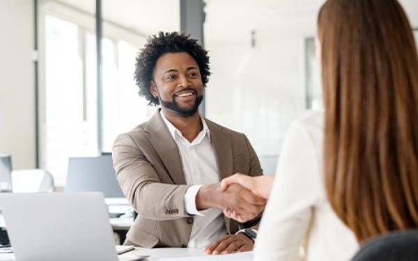employer shaking hands with employee