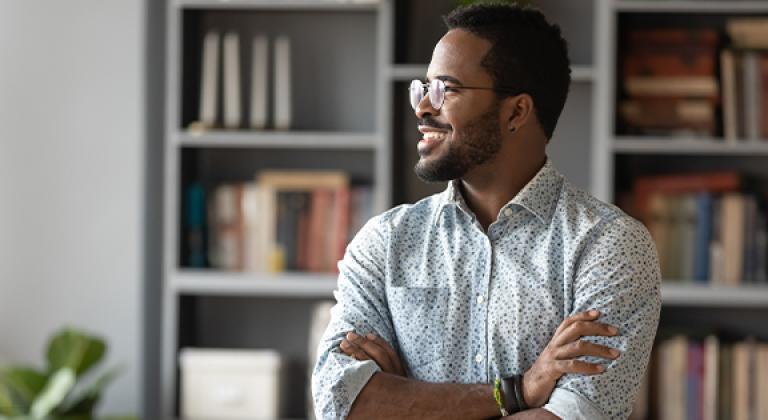 Adult man with glasses looking towards the future