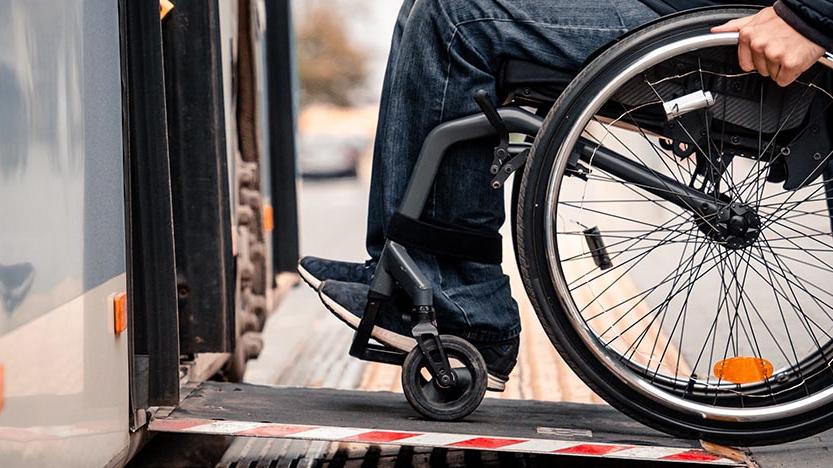 Person sitting in wheelchair with hands on wheels