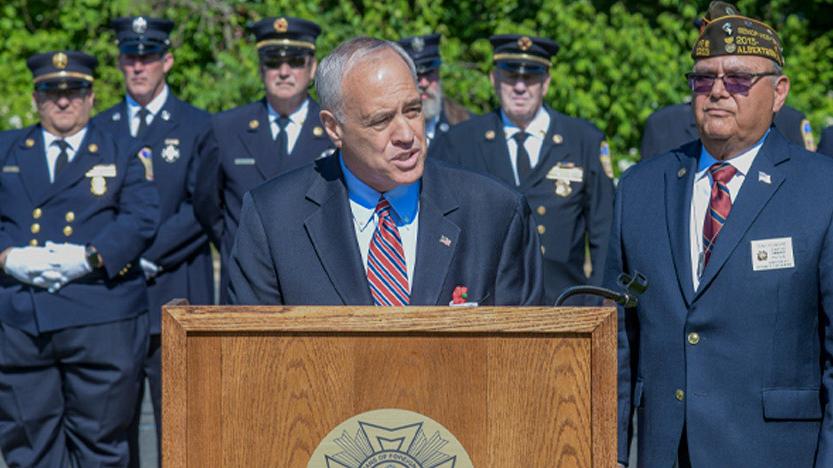 NYS Comptroller Thomas P. DiNapoli speaking at a podium