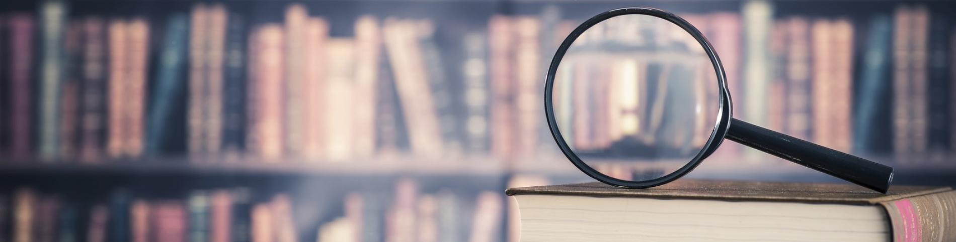 Magnifying glass on top of a book