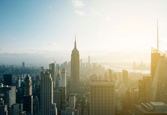 new york city skyline drone shot with the empire state building in the center of the frame