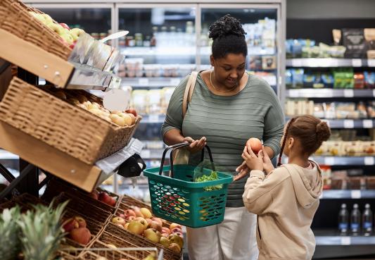 family shopping in the produce section of the grocery store