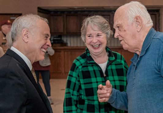 state comptroller dinapoli having a conversation with two new york state retirees