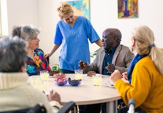 elderly adults sitting around table