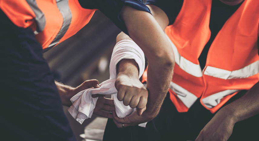 close up of manual labor worker assisting his colleague with physical injury
