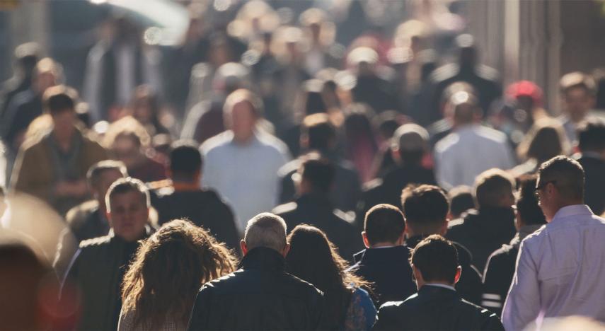 a crowd of people walking in new york city