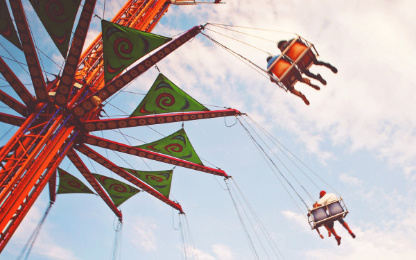 People enjoying a swing ride at the fair